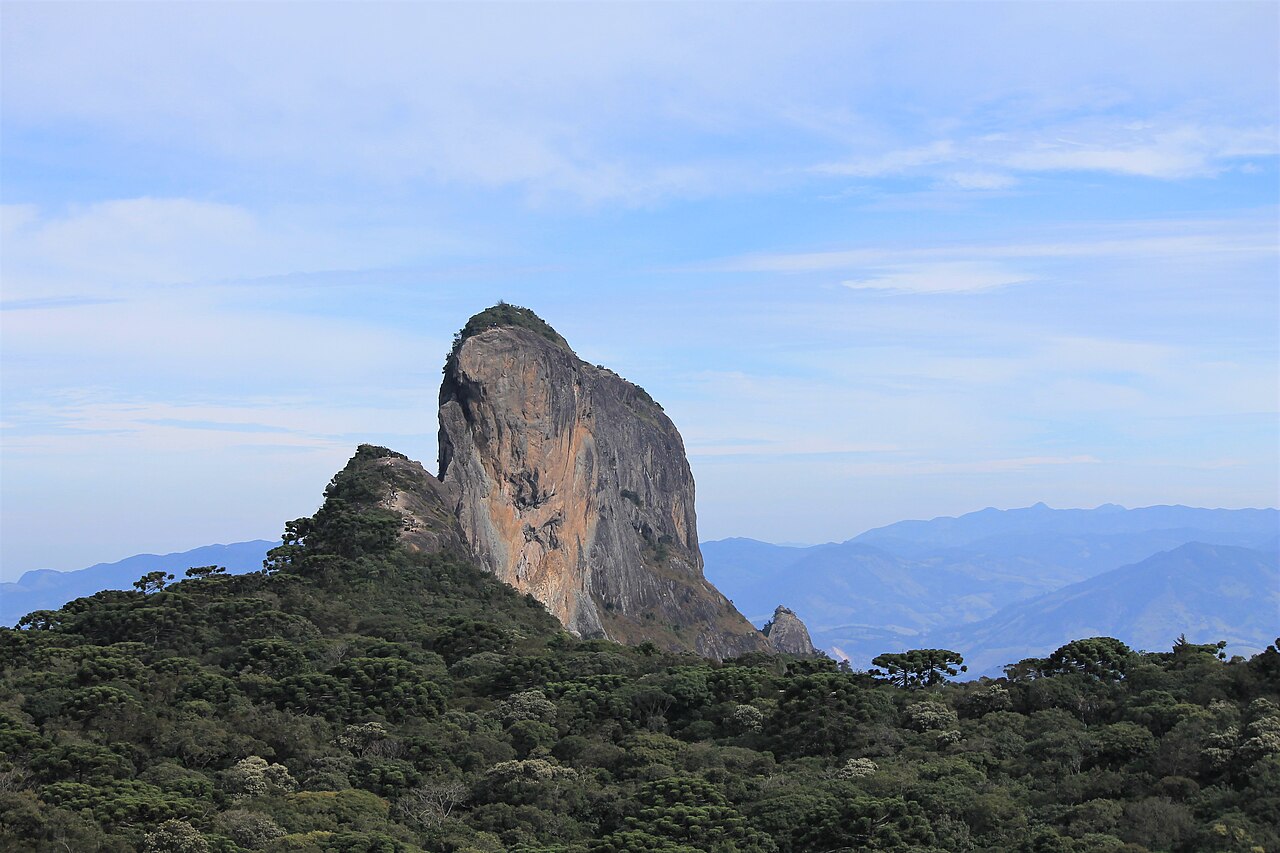 Paredão rochoso da Pedra do Baú entre morros.